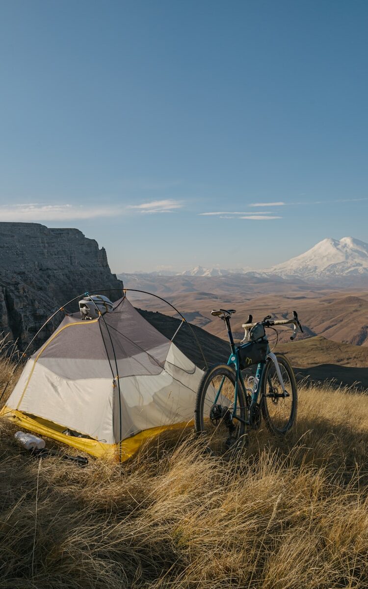 a bicycle parked next to a tent